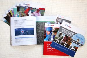 USAID print reports showing off their work