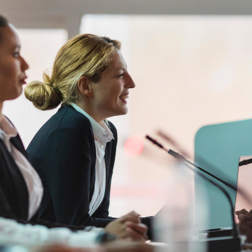 Female council member smiling during meeting