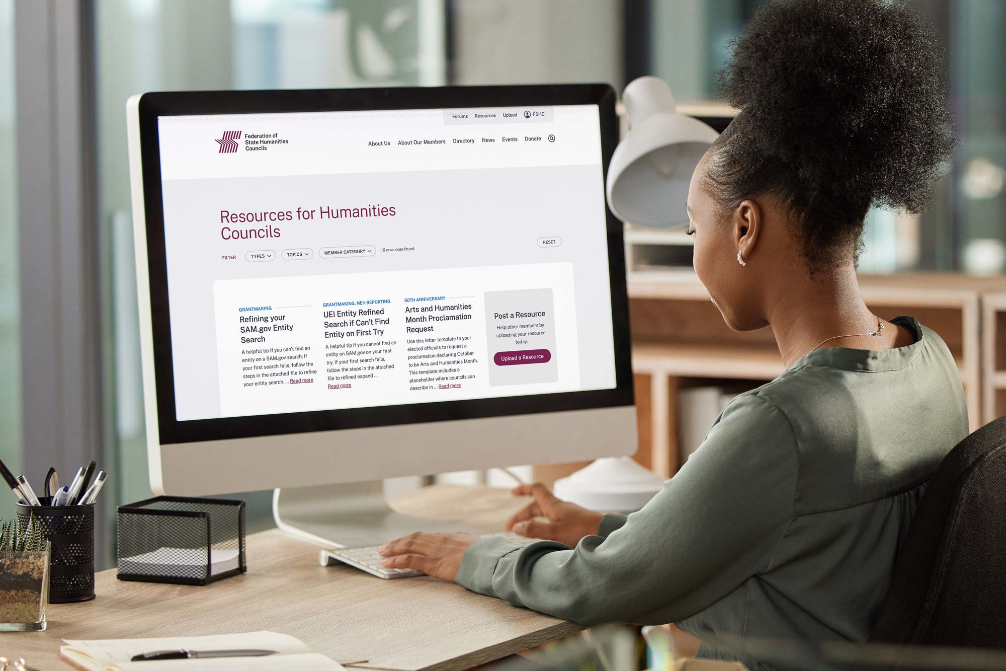 A young woman views the Member Resources area of the Federation of State Humanities Councils website. 