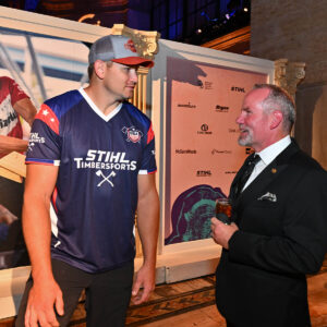 STIHL TIMBERSPORTS® Athlete Jason Lentz standing in front of sponsor wall created by openbox9